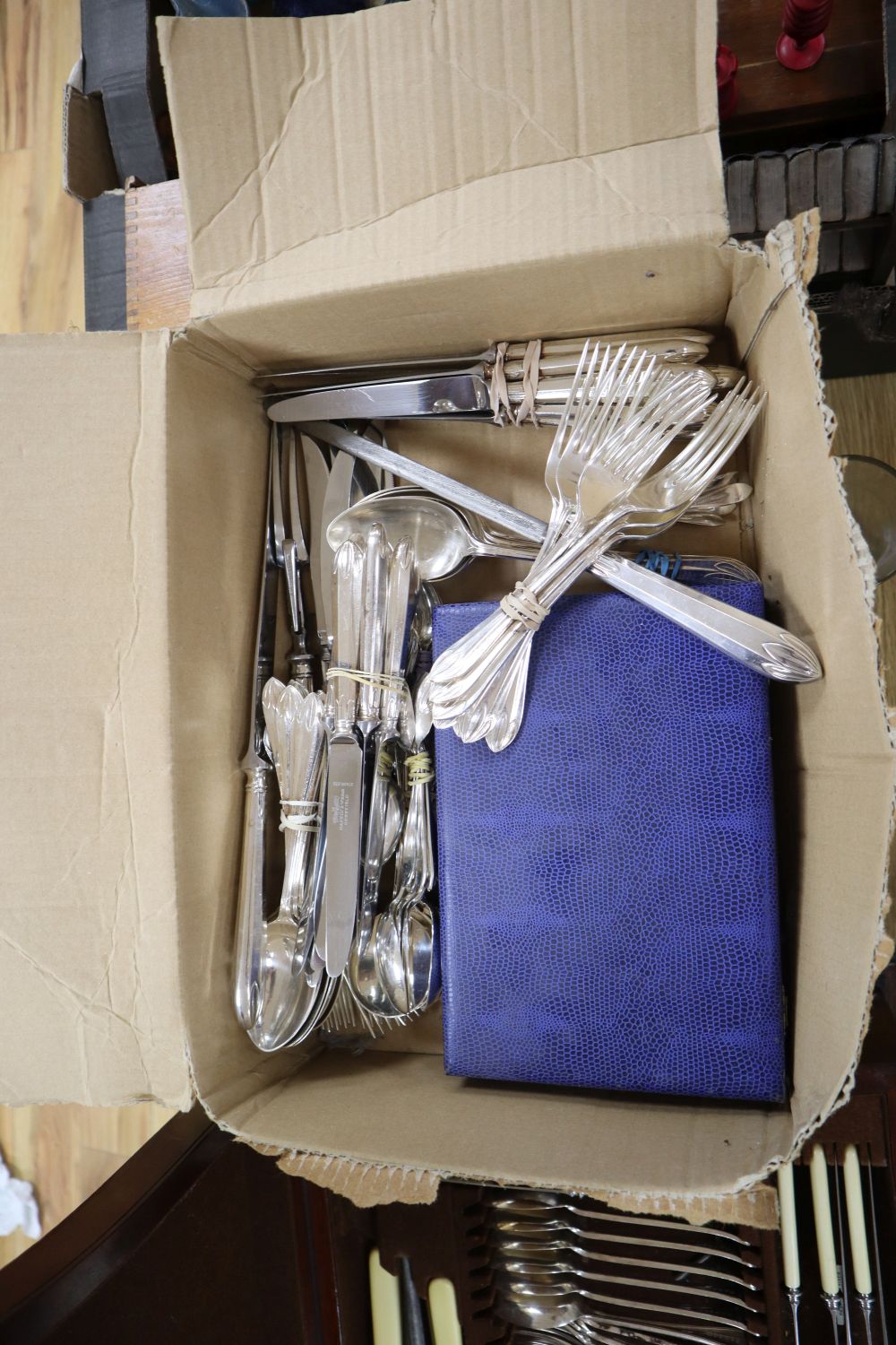 A canteen of cutlery on stand and assorted plated cutlery